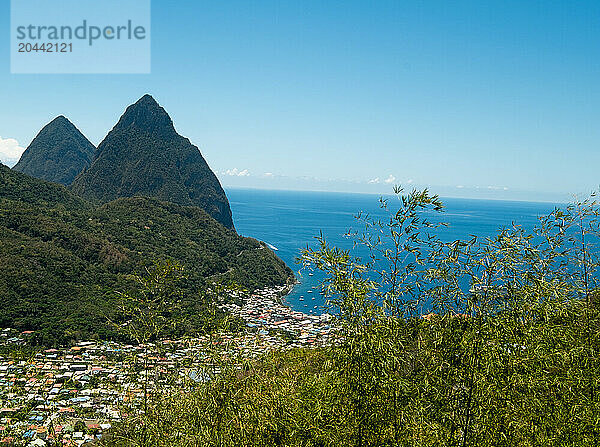 Town in hilly landscape with sea in background