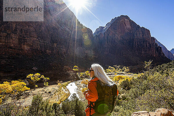 Woman hiking near Angels Landing Trail overlooking Virgin River