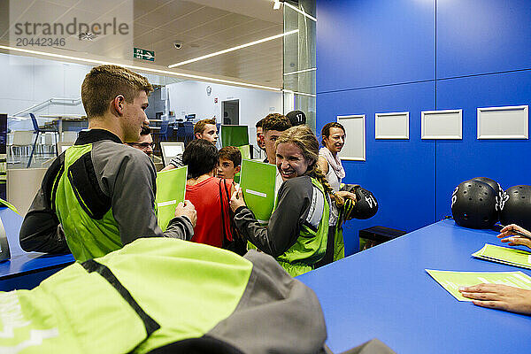 Happy participants holding certificates at indoor skydiving center