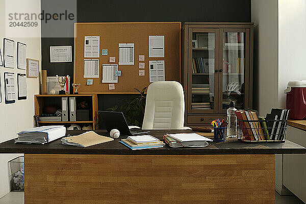 Desk with office stationary and documents in university office