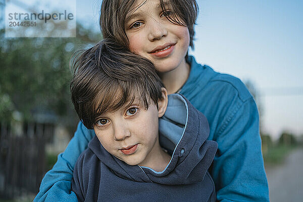 Smiling boy hugging brother