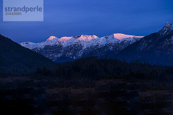 Pergine Valsugana commune with snowcapped mountains at dusk in Trento  Italy