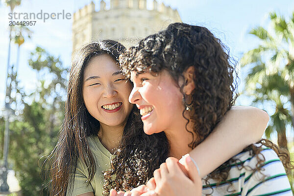 Happy friends spending leisure time in front of Torre del Oro