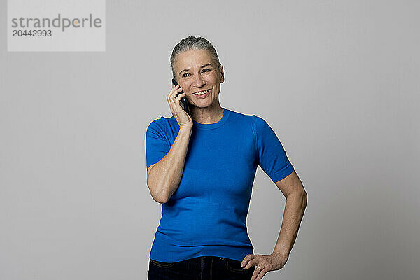 Smiling senior woman talking on mobile phone