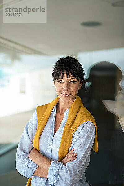 Mature businesswoman standing with arms crossed