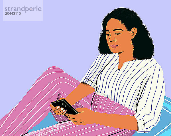 Woman using smart phone and sitting against purple background