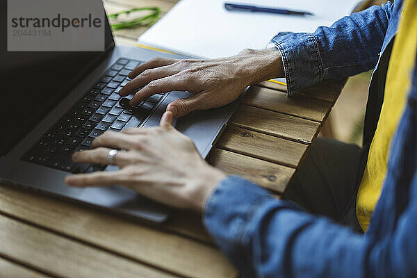 Freelancer typing on laptop at desk