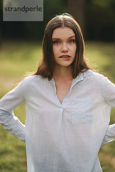 Beautiful woman with long hair standing at field