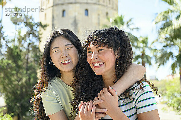 Cheerful friends standing in front of Torre del Oro