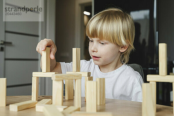 Boy playing with blocks at home