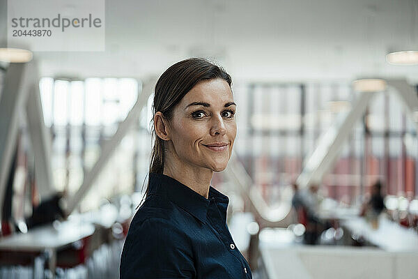 Smiling businesswoman standing at airport lobby