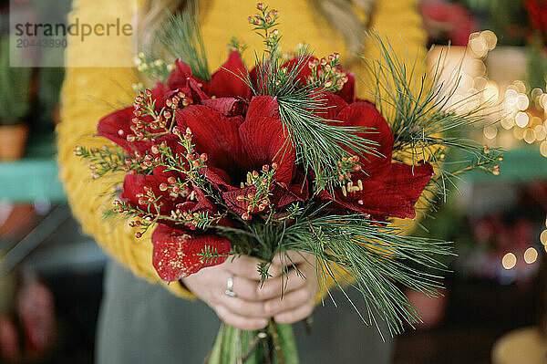 Florist holding bouquet in store