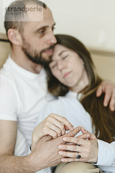 Loving couple holding hands and embracing each other