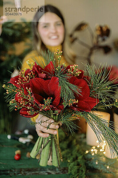 Florist holding bouquet in flower shop