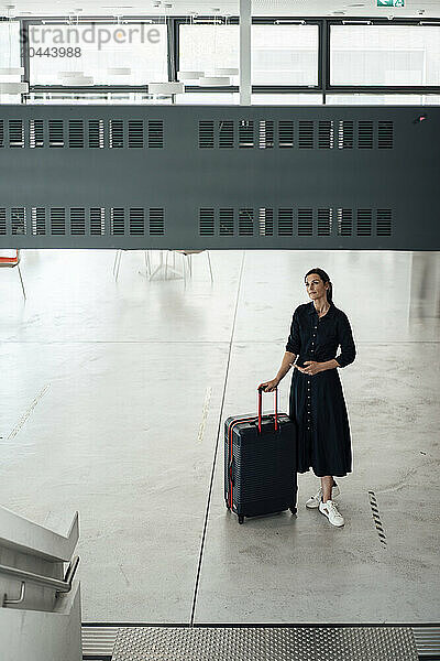 Business professional standing at airport terminal