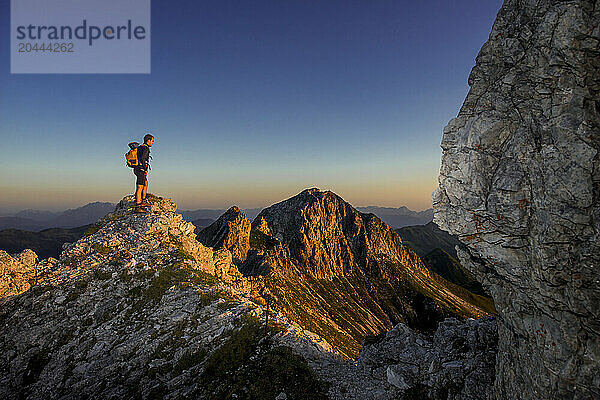 Man standing on Steinfeldspitze rock at Altenmarkt  Zauchensee  Salzburg  Austria