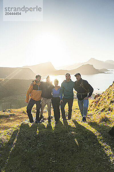 Happy friends standing at Lofoten and Nordic islands in Norway