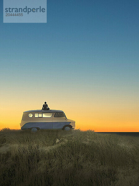 Illustration of man sitting on top of camper van at sunrise