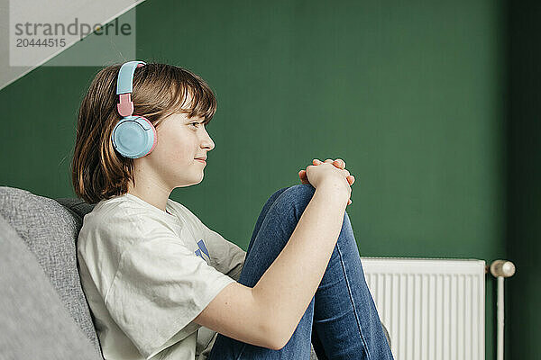 Teenage girl listening to music on headphones