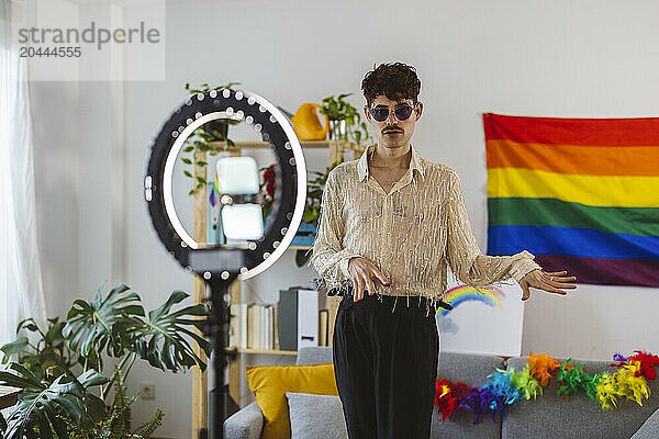 Influencer preparing for pride party and filming through smart phone attached on ring light