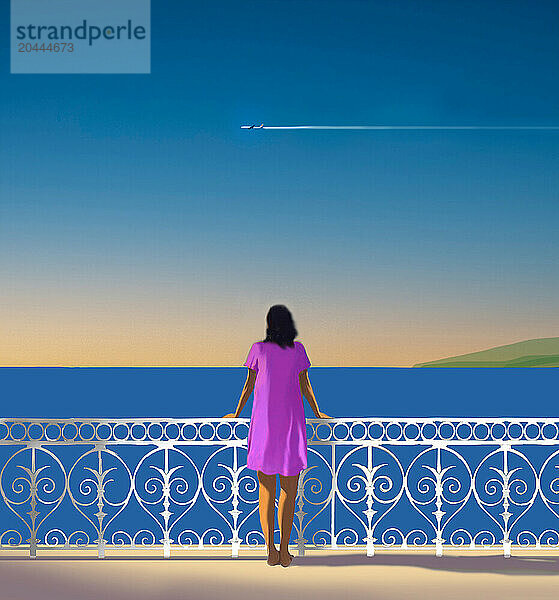 Woman looking at passing airplane from balcony