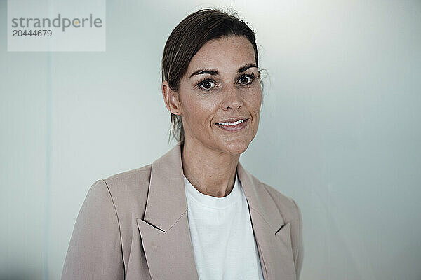 Business person standing in front of wall at office