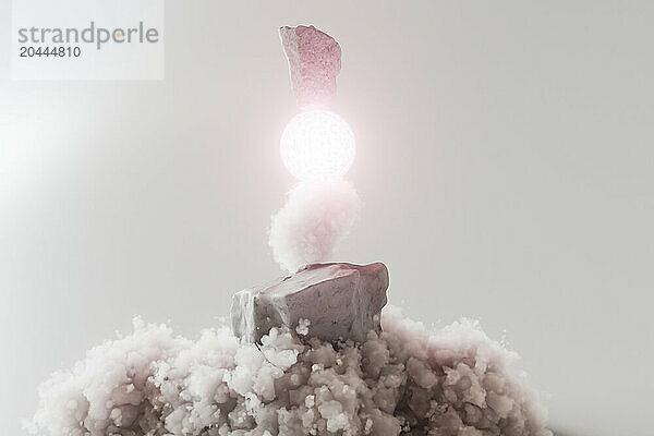 3d render of rocks and bright sphere over clouds