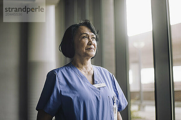 Senior female healthcare worker in medical scrubs at hospital