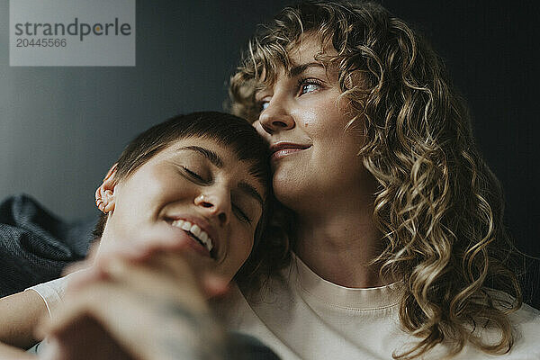 Low angle view of thoughtful lesbian woman with girlfriend