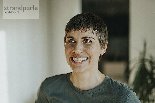 Woman with toothy smile and short hair