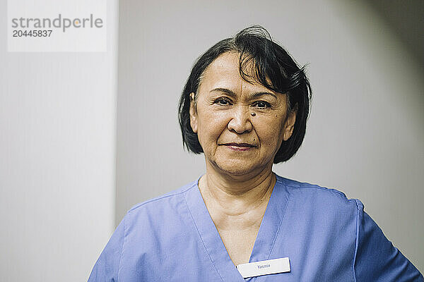 Portrait of confident female medical expert at hospital