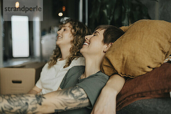 Happy lesbian couple relaxing during relocation