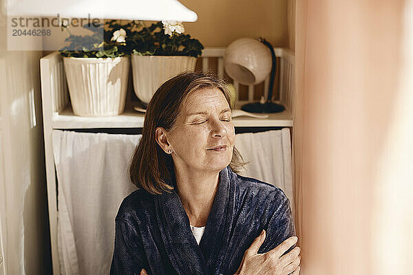 Smiling senior woman with medium length hair at home