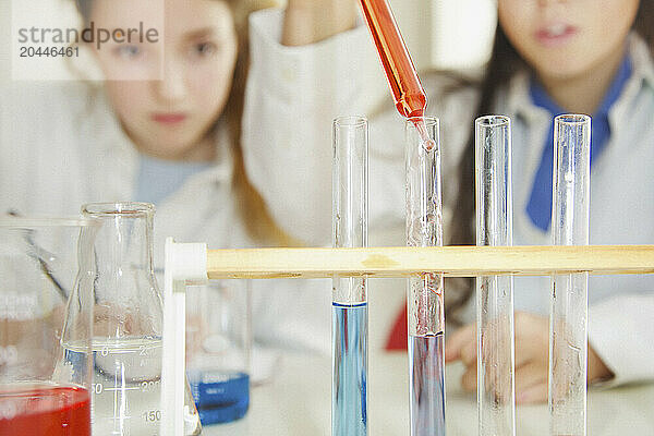 Schoolgirls Experimenting with Alkaline Acid pH at Chemistry Class