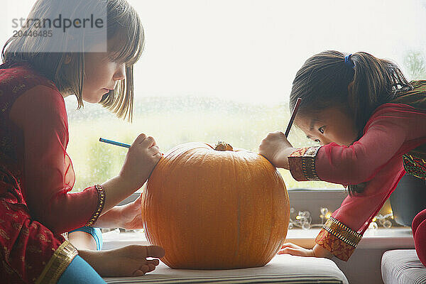 Young Girls Making a Pumpkin Lantern