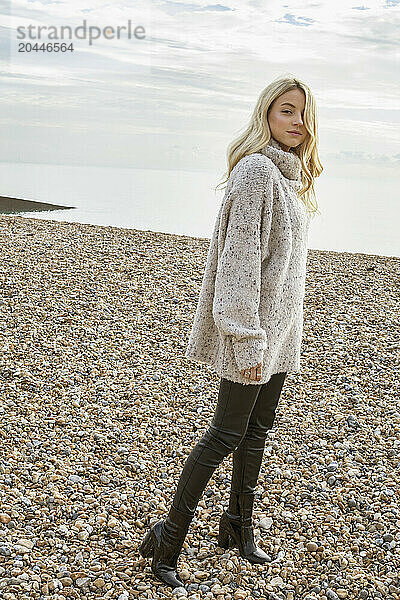 Young Woman on Pebble Beach in Winter