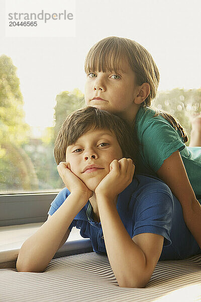 Young Girl Lying on Brother's Back