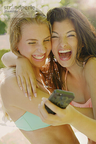 Two Young Women Taking Selfie Laughing