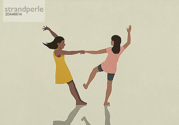 Carefree  barefoot girl friends holding hands and dancing on beige background