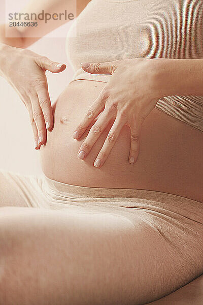 Feathering Therapeutic Massage  Pregnant Woman Massaging her Stomach