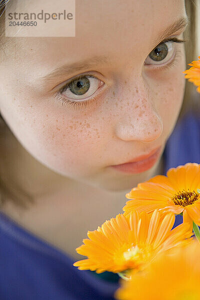 Young Girl Holding Orange Flowers