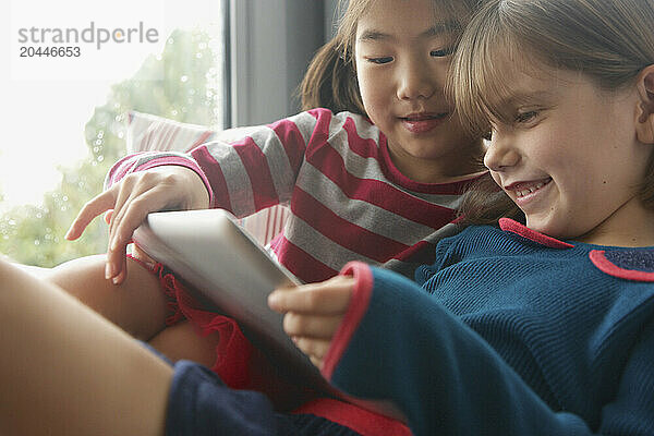 Young Girls Using Digital Tablet Smiling