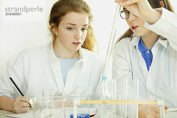 Schoolgirls Experimenting with Alkaline Acid pH at Chemistry Class