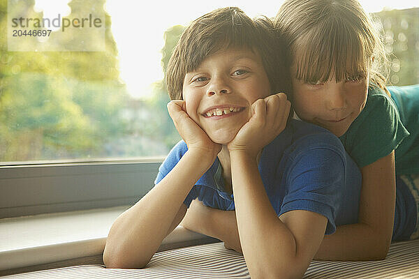 Young Girl Lying on Brother's Back