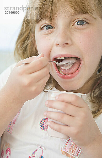 Young Girl Eating Yogurt