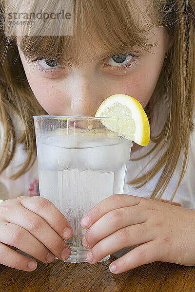 Girl Drinking Water with Ice and Lemon