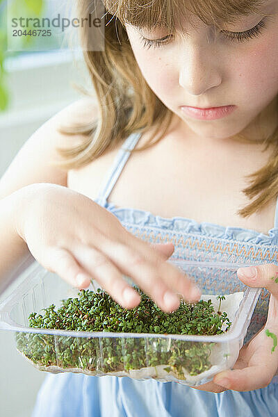 Young Girl Inspecting Watercress Seedlings