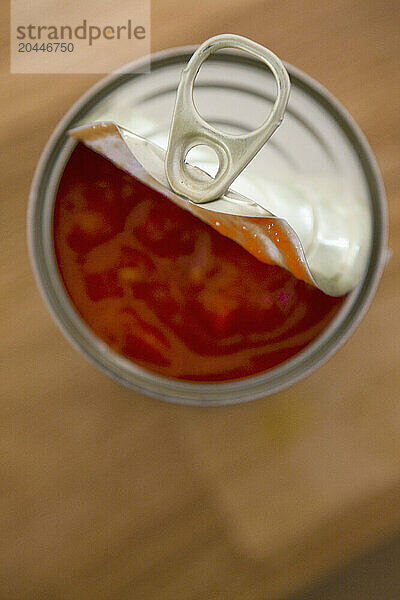 Elevated view of an open tin of tomatoes