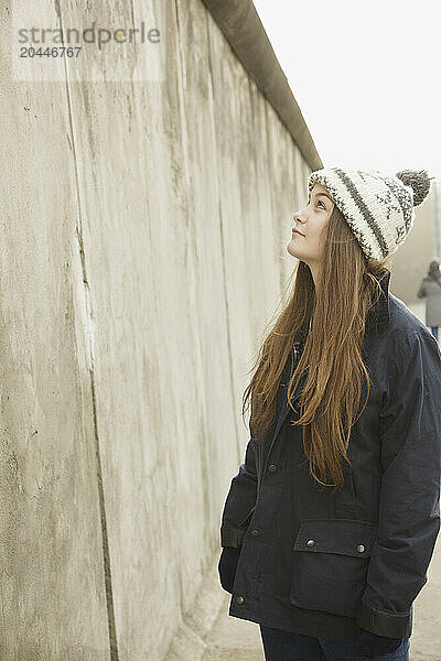 Teenage Girl in front of Berlin Wall  Berlin  Germany