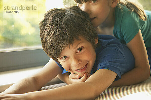 Young Girl Lying on Brother's Back